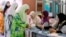 Women line up to vote at a polling station at Penanti in Penang state in northern Malaysia, May 5, 2013. 