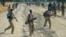 Sudan People's Liberation Army (SPLA) soldiers walk along a road in Mathiang near Bor, Jan. 31, 2014. 
