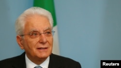 FILE - Italian President Sergio Mattarella speaks during the news conference.