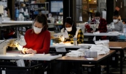 Jennifer Nagle sews hospital masks as the spread of coronavirus disease continues, on day one of turning the "Detroit Sewn" facility into a production facility for hospital masks, in Pontiac, Michigan, March 23, 2020.