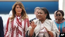 First lady Melania Trump walks with Ghana's first lady Rebecca Akufo-Addo as she arrives at Kotoka International Airport in Accra, Ghana, Oct. 2, 2018.