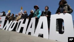 Protesters hold letters reading "NO THAAD" during a rally to oppose a plan to deploy an advanced U.S. missile defense system called Terminal High-Altitude Area Defense, or THAAD, near U.S. Embassy in Seoul, South Korea, April 26, 2017. 