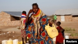 FILE - A Turkana woman washes her face at a water point within Kalobeyei Settlement outside the Kakuma refugee camp in Turkana county, northwest of Nairobi, Kenya, Feb. 1, 2018. 