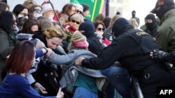 Law enforcement officers scuffle with women during a rally challenging official presidential election results, in Minsk, Belarus, September 19, 2020.