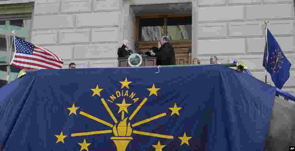Mike Pence, left, is sworn in as Indiana's 50th governor by Chief Justin Brent E. Dickson during an inaugural ceremony at the Statehouse in Indianapolis, Jan. 14, 2013.
