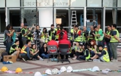 Protesters address the media at the campus of the Polytechnic University in Hong Kong, Nov. 24, 2019.