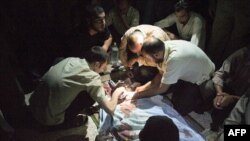 Syrians mourn over Mohammed Hafez, 30, who was killed by a gunshot to the head in Izaz, July 13, 2012