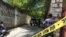 Journalists stand by a yellow police cordon near the residence of Haiti&#39;s President Jovenel Moise after he was shot dead by unidentified attackers, in Port-au-Prince, Haiti, July 7, 2021.