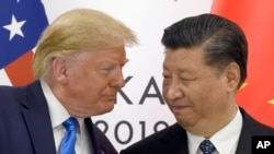 FILE - President Donald Trump, left, meets with Chinese President Xi Jinping on the sidelines of the G-20 summit in Osaka, Japan, June 29, 2019. 