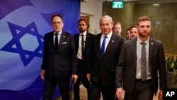 Israeli Prime Minister Benjamin Netanyahu, center, arrives for a weekly Cabinet meeting in Jerusalem on Jan. 15, 2023. 