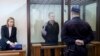 Journalist Andrzej Poczobut, center, stands in a defendants' cage during a court session in Grodno, Belarus, Jan. 16, 2023. 