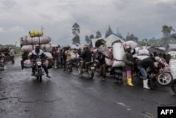 Motorcyclists transport charcoal to Kibati at the foot of Nyiragongo volcano in Virunga National Park, Jan. 13, 2023.