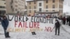 Climate activists display a banner during a protest ahead of the World Economic Forum (WEF) 2023 in the Alpine resort of Davos, Switzerland, Jan. 5, 2023. 