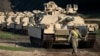 FILE - A U.S. walks near Abrams battle tanks near Vilnius, Lithuania, on Oct. 21, 2019.