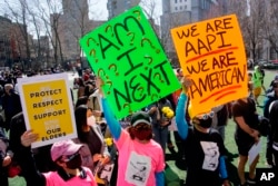 FILE- People take part in a rally against hate and confront the rising violence against Asian Americans at Columbus Park in New York's Chinatown on March 21, 2021.