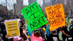 People take part in a rally against hate and confront the rising violence against Asian Americans at Columbus Park in New York's Chinatown on March 21, 2021. 