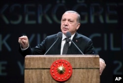 Turkish President Recep Tayyip Erdogan addresses academics at his palace in Ankara, Turkey, Sept. 26, 2017.