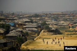 FILE - Rohingya refugees play football at Kutupalong refugee camp in Cox's Bazaar, Bangladesh, March 27, 2018.