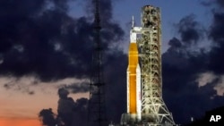 FILE - The NASA Artemis I rocket with the Orion spacecraft aboard is seen on pad 39B just after sunset at the Kennedy Space Center, in Cape Canaveral, Florida, June 27, 2022.