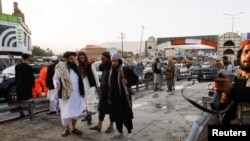 Taliban fighters stand guard at the site of a blast in Kabul, Afghanistan, Aug. 6, 2022. 