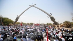 Followers of Shiite cleric Muqtada al-Sadr gather during open-air Friday prayers at Grand Festivities Square within the Green Zone, in Baghdad, Iraq, Aug. 5, 2022. 