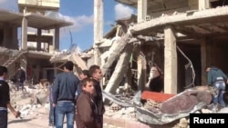 A damaged area is pictured after a car bomb in Qatana, near Damascus December 13, 2012 in this handout photograph released by Syria's national news agency SANA.