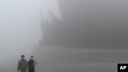 Pyongyang residents visit Mansu Hill to pay respect to bronze statues of North Korean late leaders Kim Il Sung and Kim Jong Il in Pyongyang, North Korea, Feb. 12, 2021. 