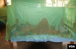 A person sleeps under a mosquito net in Balaka district, Malawi, Sept. 28, 2022, as people in the country are encouraged to do to help prevent malaria. (Lameck Masina/VOA)