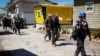 Federal Emergency Management Agency personnel and Lee County Sheriff officers walk through a trailer park after Hurricane Ian caused widespread destruction, in Fort Myers Beach, Florida, Oct. 3, 2022.