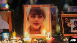 Items are shown during a vigil for Mahsa Amini, who died in custody of Iran's morality police, in Los Angeles, Sept. 29, 2022. As of Sept. 30, groups tracking arrests of journalists in Iran who covered protests set off by her death have documented 28 detentions.