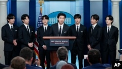 FILE - RM, center, accompanied by other K-pop supergroup BTS members from left, V, Jungkook, Jimin, Jin, J-Hope, and Suga speaks during the daily briefing at the White House in Washington, May 31, 2022. 