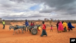 FILE - People arrive at a displacement camp on the outskirts of Dollow, Somalia, Sept. 20, 2022.