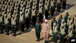 FILE - In this photo provided by the Revolutionary Guard's Ground Force Oct. 17, 2022, troops stand while attending a manoeuver in northwestern Iran.