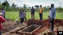 FILE - Relatives of a woman who died from Ebola prepare her grave in Kijavuzo village, Mubende district, Uganda, Sept. 29, 2022.