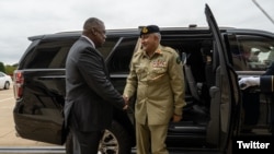 U.S. Secretary of Defense Lloyd Austin greets Pakistan’s Chief of Army Staff, Gen. Qamar Javed Bajwa, at the Pentagon, outside Washington, in a photo published Oct. 5, 2022, on Austin's Twitter feed.