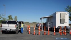 FILE - Peggy Franklin, a volunteer nurse from Reno, administers vaccines at a mobile vaccination clinic held at a tribal health center on the Fallon Paiute-Shoshone Reservation and Colony on May 18, 2021 in Fallon, Nev.