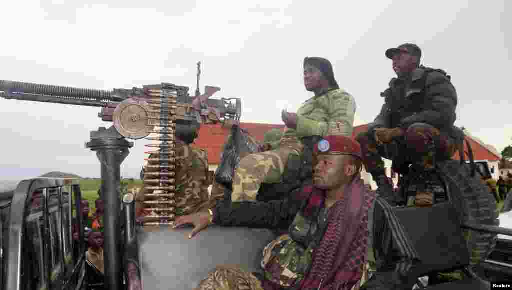 Congolese soldiers arrive on a truck at Rumangabo military base, formerly held by M23 rebels, north of Goma, Oct. 28, 2013.
