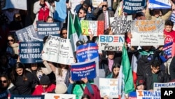A crowd is seen gathered in front of the White House urging President Joe Biden to expand work permits for long-term immigrants, in Washington, Nov. 14, 2023. (Joy Asico/AP Images for ABIC Action)