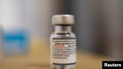 FILE - A vial of the Pfizer-BioNTech COVID-19 booster vaccine targeting BA.4 and BA.5 omicron sub variants is pictured at Skippack Pharmacy in Schwenksville, Pa., Sept. 8, 2022.