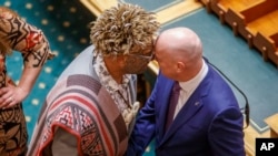 New Zealand Prime Minister Christopher Luxon, right, shakes hands and performs a hongi with Te Pati Maori co-leader Rawiri Waiti in the chamber during the Swearing-in ceremony at Parliament in Wellington, New Zealand, Tuesday, Dec. 5, 2023.