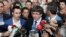 Catalan President Carles Puigdemont, center, speaks to the media at a sports arena which was designated to serve as a polling station by the Catalan government, in Sant Julia de Ramis, near Girona, Spain, Oct. 1, 2017. 