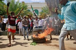 Sudanese protesters shout slogans outside the Council of Ministers in the capital Khartoum, Aug. 17, 2020.