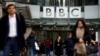 FILE - Pedestrians walk past a BBC logo at Broadcasting House, London. In a statement posted on Twitter, the BBC said it is ‘disappointed’ by China’s actions.