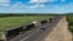 A drone view shows stranded trucks at the side of the road, near the Lebombo border outside Mbombela, South Africa, Nov. 29, 2024. Mozambique’s political instability has caused traffic congestion and delays at its borders, affecting trade. 