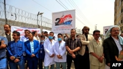 Yemeni health care workers protest against severe fuel shortages outside the United Nations office in the rebel-held capital Sanaa on June 14, 2021.