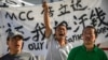 FILE - Chinese laborers Jingbao Zhao, left, Xiaoli Wang, center, and Yongbo Sun protest in front of the Imperial Pacific Casino in Saipan, the Northern Mariana Islands, July 26, 2017. 