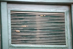 FILE - Arrested prisoners' fingers are seen through a window in September 2005 after a riot by inmates who tried to set fire to part of overcrowed Ikoyi Prison in Lagos, Nigeria.