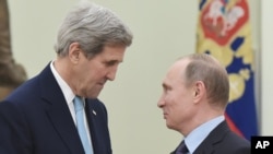 FILE - U.S. Secretary of State John Kerry, left, speaks with Russia's President Vladimir Putin during a meeting at the Kremlin in Moscow, Dec. 15, 2015.