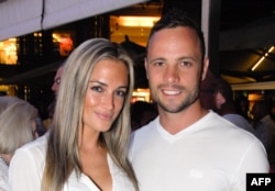 Olympian sprinter Oscar Pistorius posing next to his girlfriend Reeva Steenkamp at Melrose Arch in Johannesburg, Jan. 26, 2013.