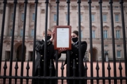 An announcement is attached to the fence of Buckingham Palace stating that Britain's Prince Philip, husband of Queen Elizabeth, has died at the age of 99, in London, Britain.